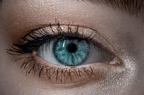 persons blue eyes in close up photography
